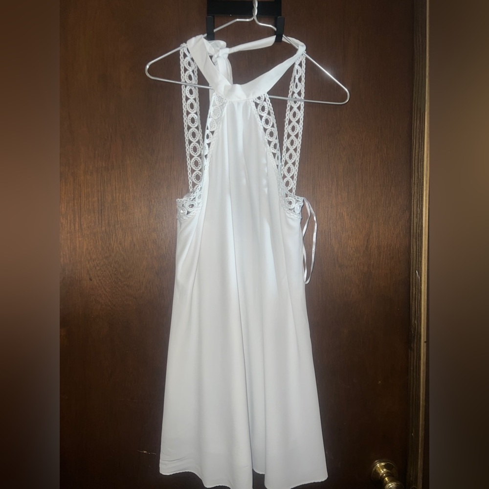 White halter top dress, ties at back of the neck. Light and flowing material.